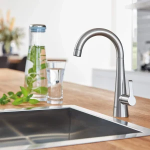 Elegant GROHE gooseneck kitchen faucet installed on wooden counter
